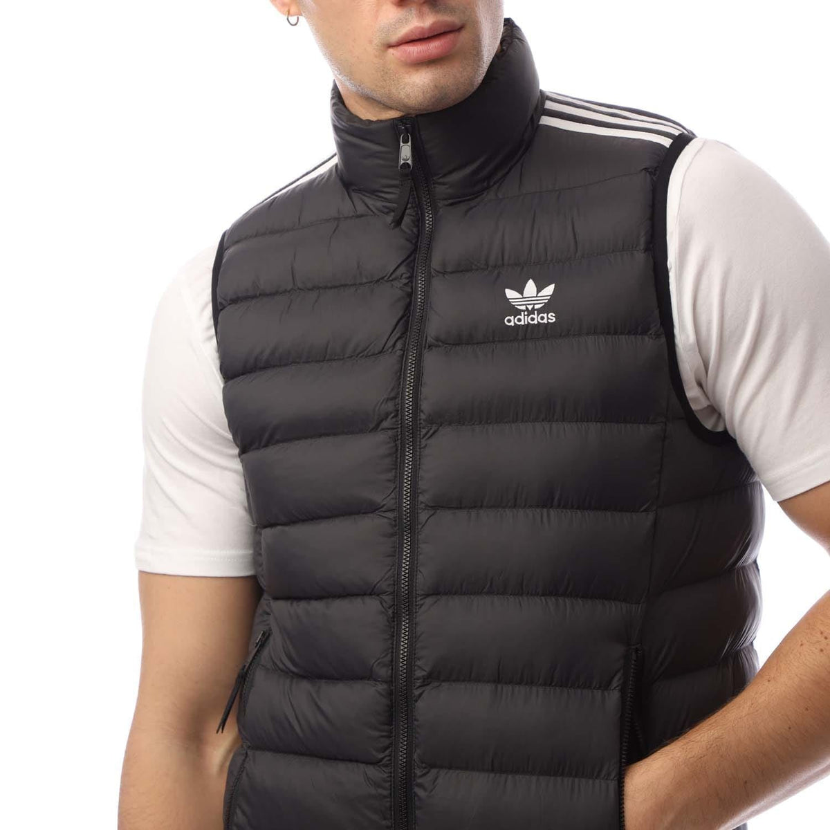 Black padded puffer vest with stand-up collar, zip front, and adidas logo on chest