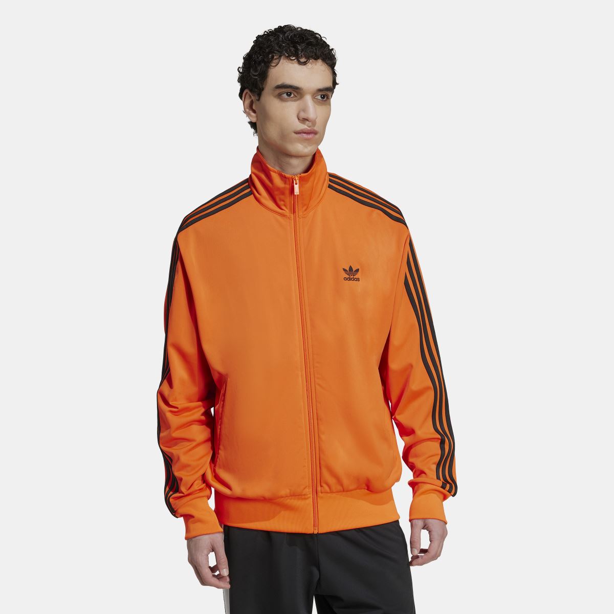 adidas Originals Adicolor Classics Firebird Track Top, navy blue tracksuit jacket with white stripes and zip closure.