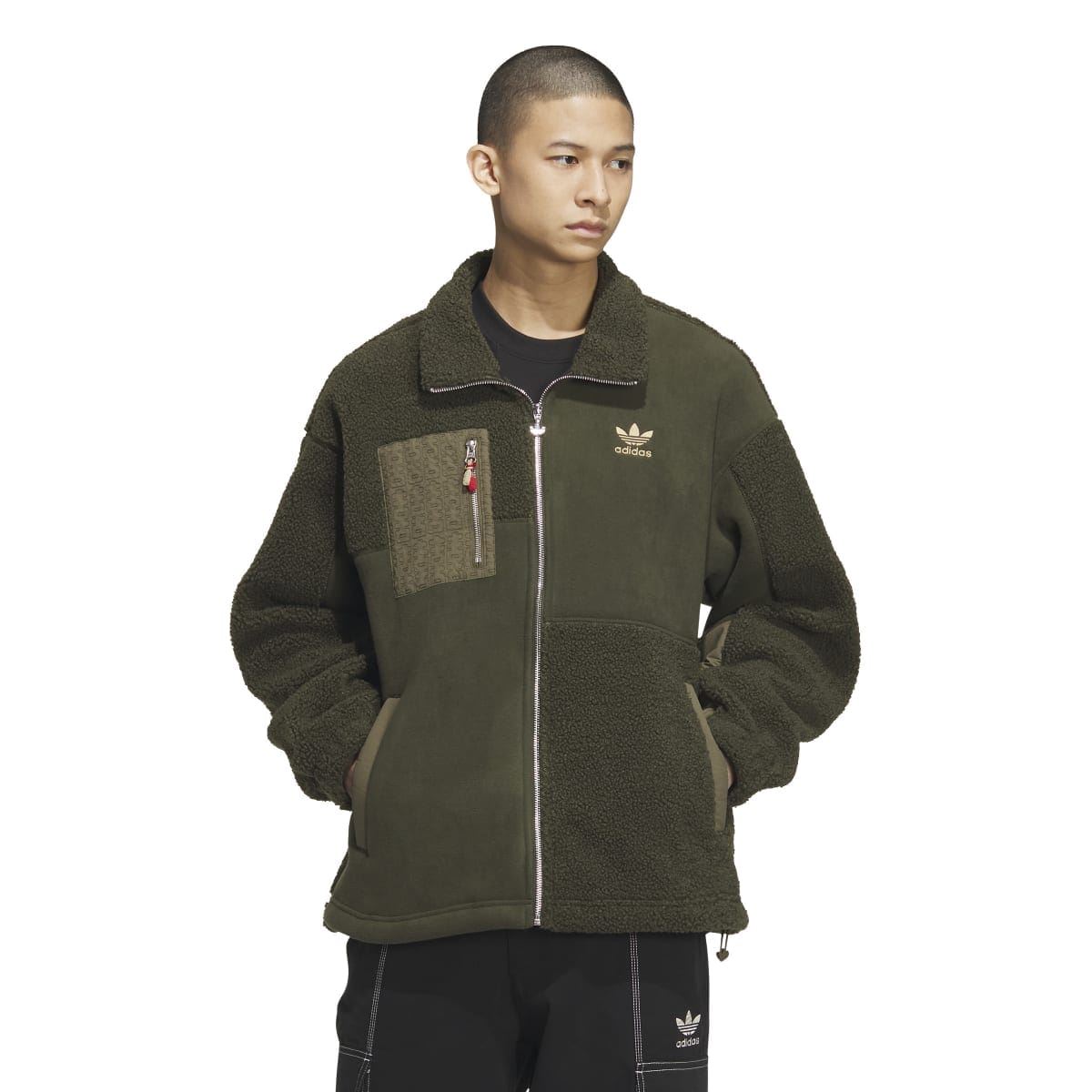 Olive green Sherpa full-zip jacket on model, stand collar, Adidas logo, fleece side panels