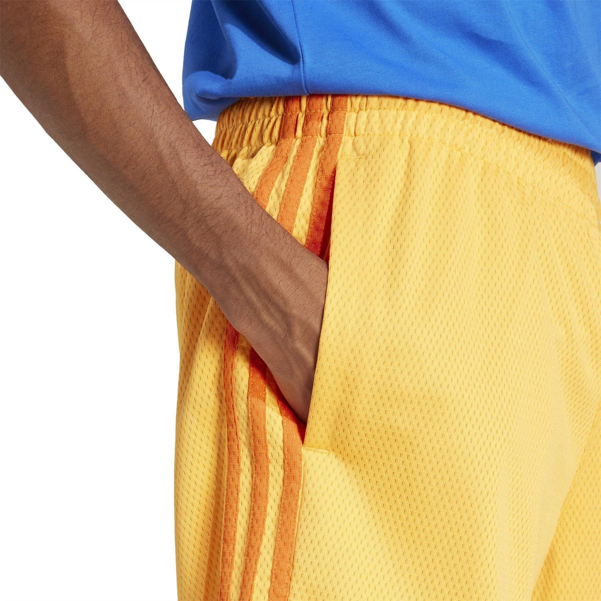Yellow shorts with elastic waistband, orange side stripes, and textured fabric