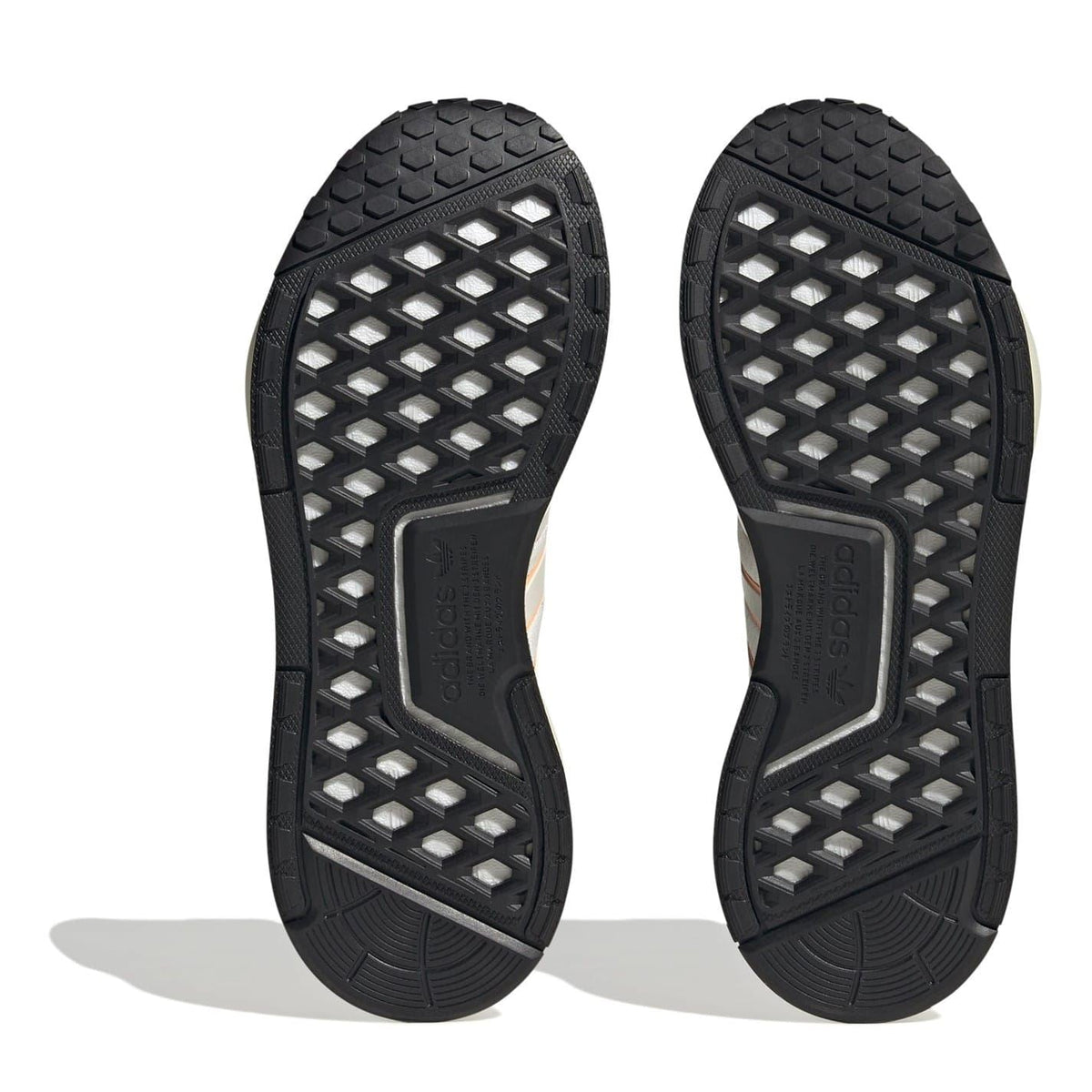 Black NMD low-top sneaker outsoles with grid tread and adidas branding