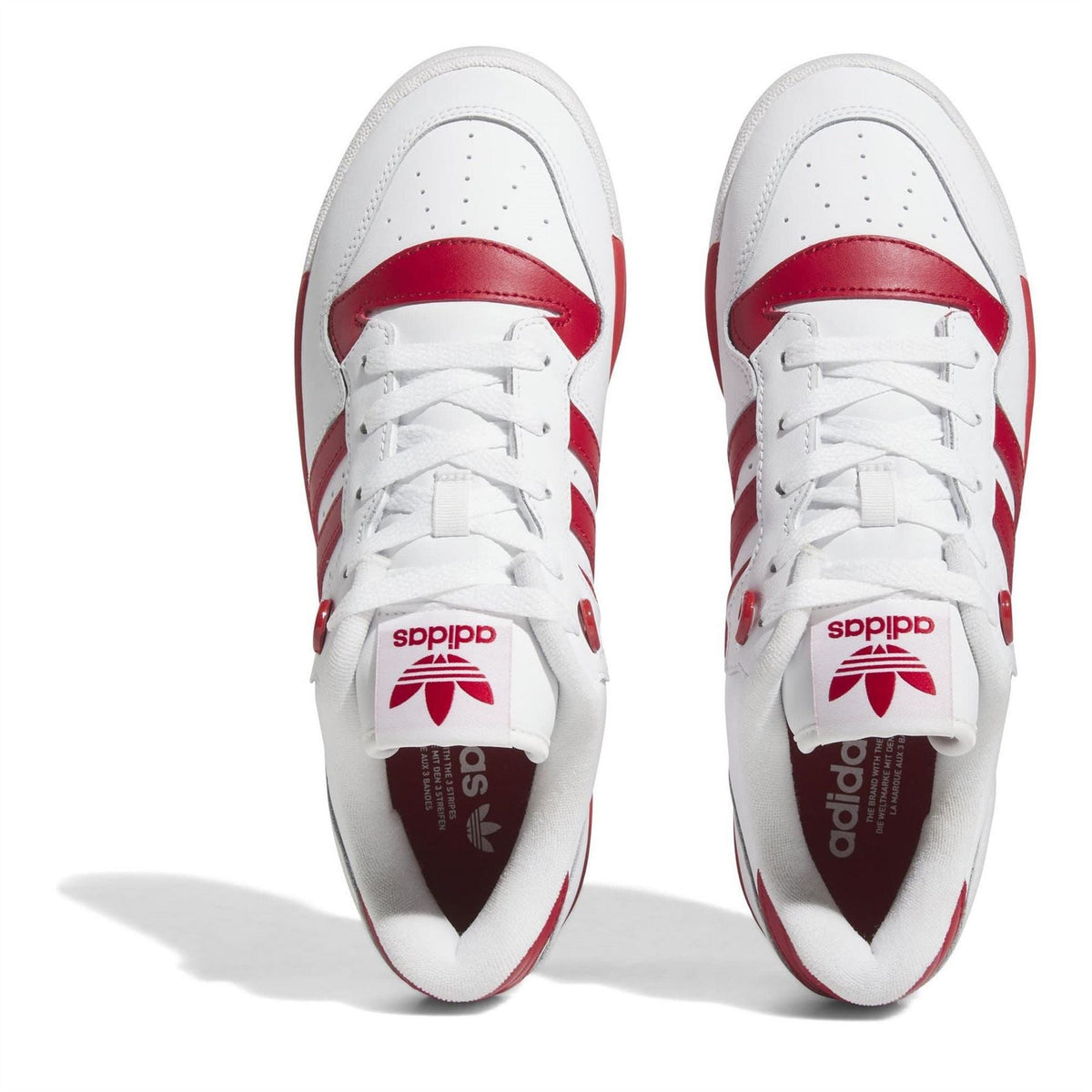 Pair of white adidas Originals Rivalry low-top trainers with red lining and lace overlay