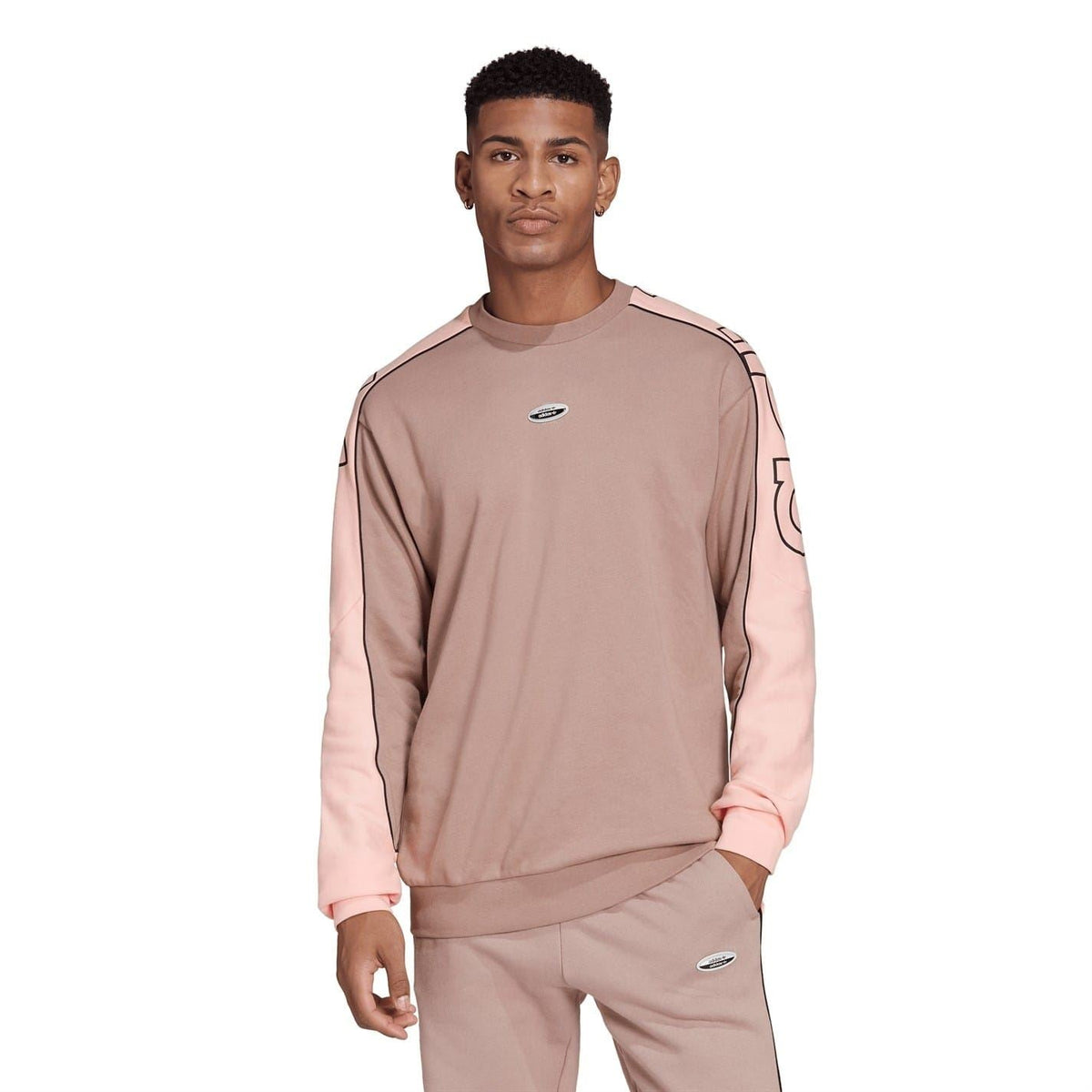 Front view relaxed crewneck sweatshirt in chalky brown with pink contrast sleeves and adidas logo