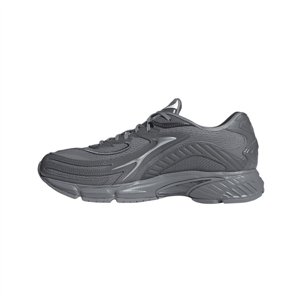 Grey low-top trainers with three stripes, lace-up closure, and thick cushioned sole