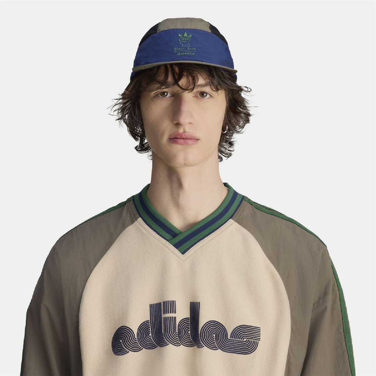 adidas cap worn by model: olive crown with blue band and dark mesh top