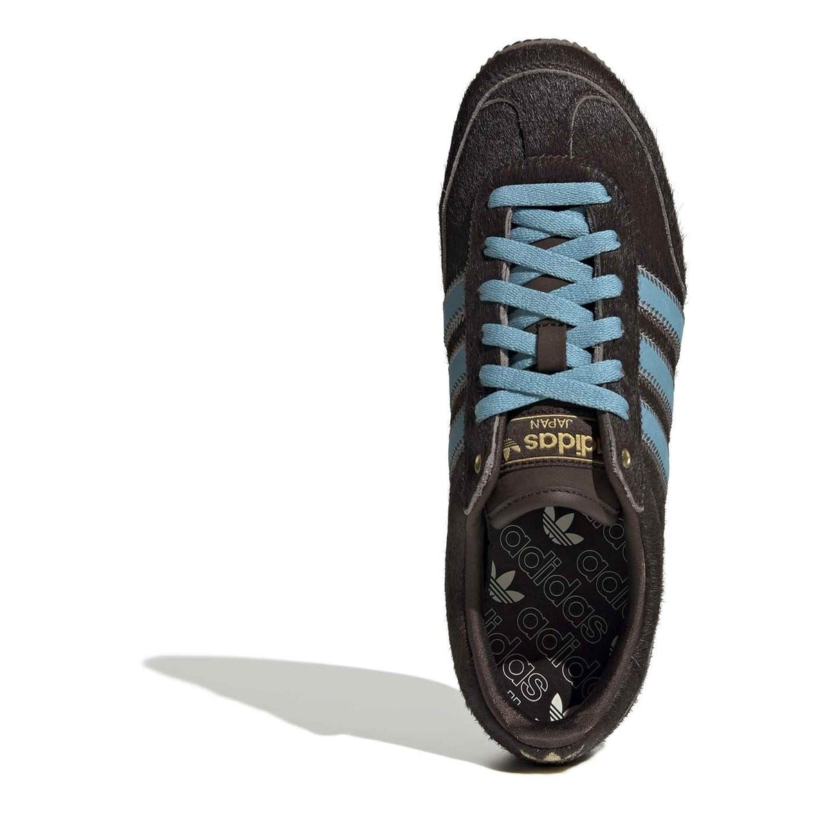 adidas Originals Japan sneakers, dark brown upper with light blue lace and Adidas branding on tongue