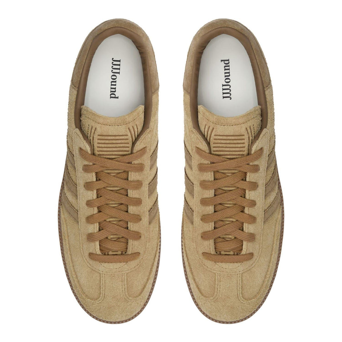 Brown suede trainers with brand-printed insoles visible at the openings