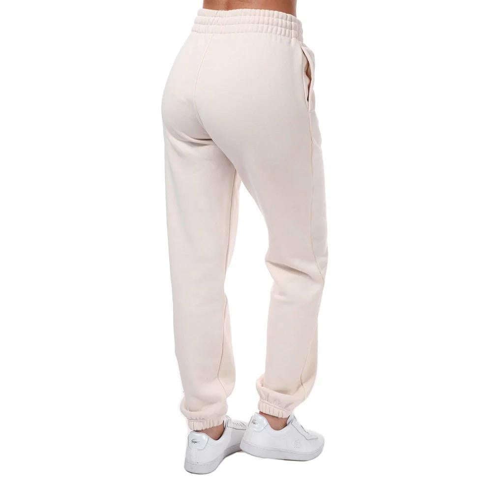 adidas Originals Womens Adicolor Essentials fleece joggers in light grey with relaxed fit and elastic waistband, casual track pants.