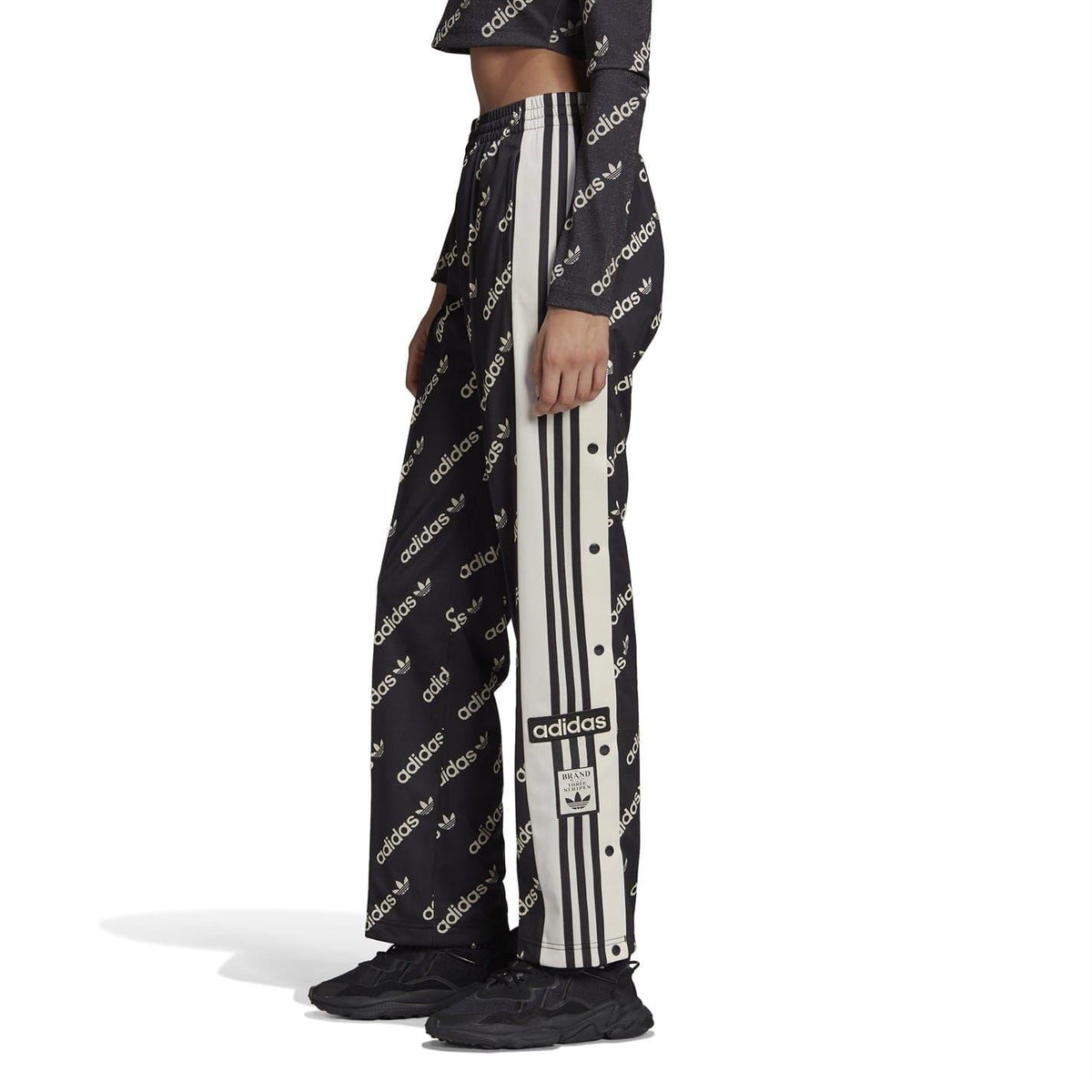 Black jogger sweatpants with allover adidas print and contrasting vertical side stripes