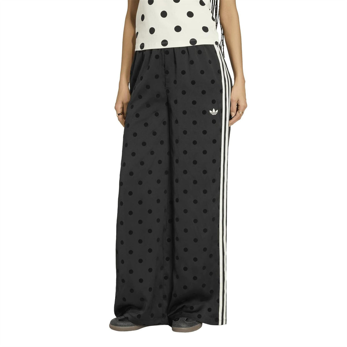 Black polka-dot wide-leg pants with elastic waist and white side stripes