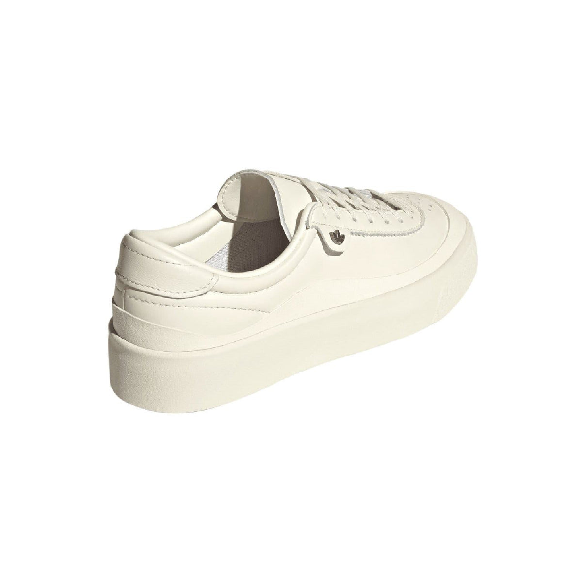 White low-top trainers with padded collar, heel tab, and lace-up front.