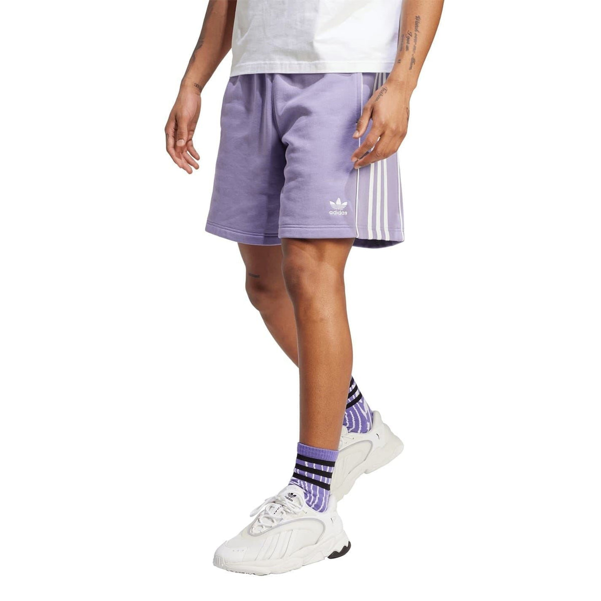 Lavender athletic shorts with three white side stripes and small adidas logo