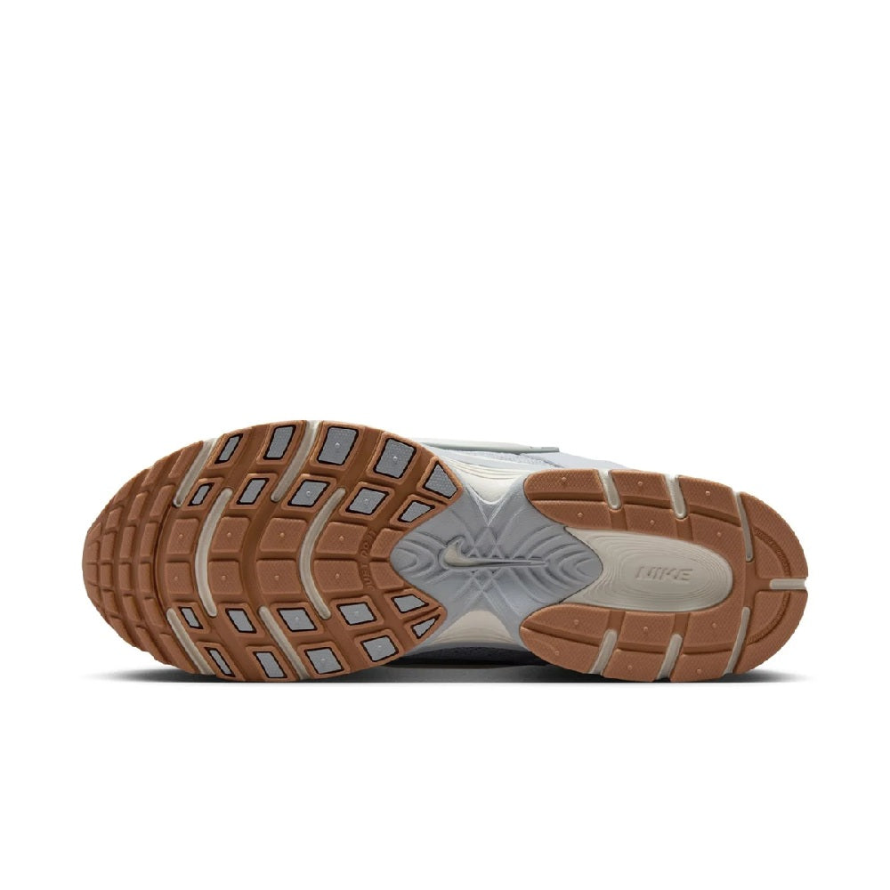 Men's Nike running shoes outsole view with rubber traction pods in tan and grey