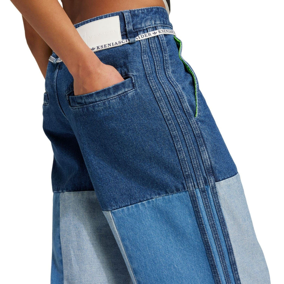 Patchwork denim jeans with dark blue top panel, light blue pocket area, and stitched seams.