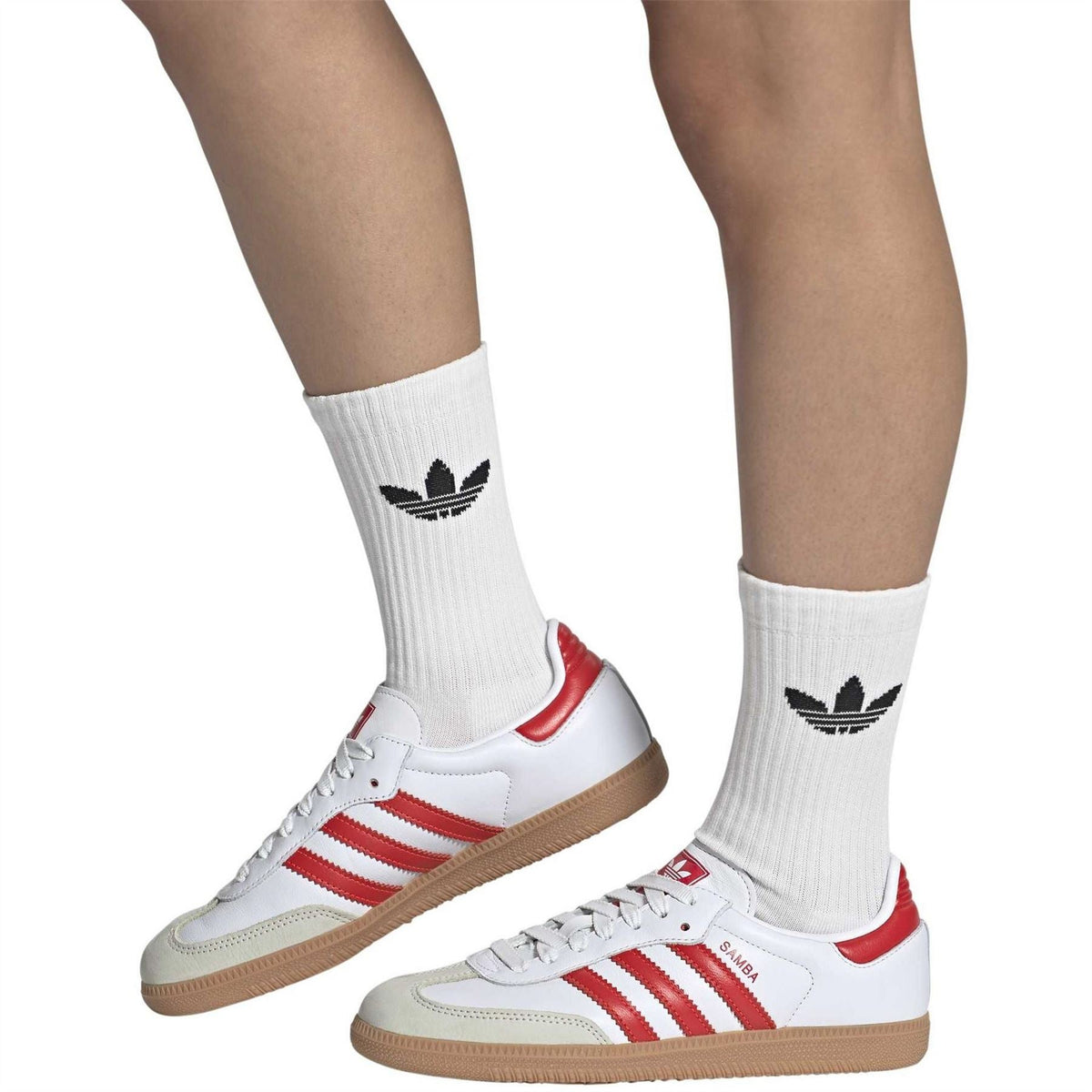 adidas Samba OG sneakers with red-and-white stripes and gum sole, worn with white socks
