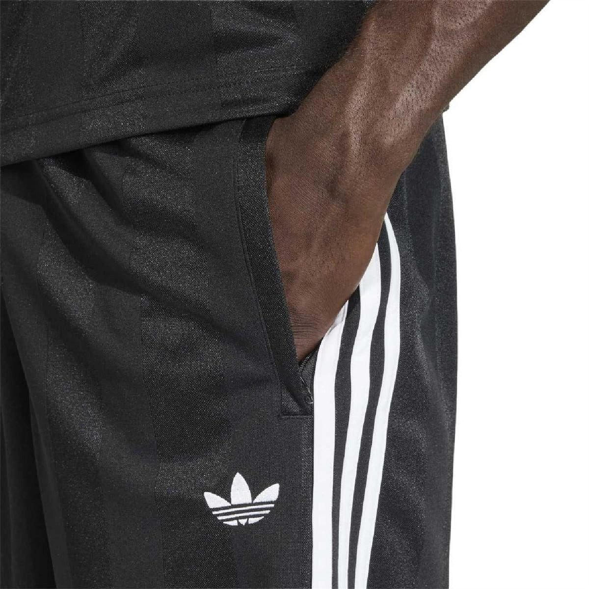Black shorts close-up: adidas trefoil logo and white 3-stripe side panel