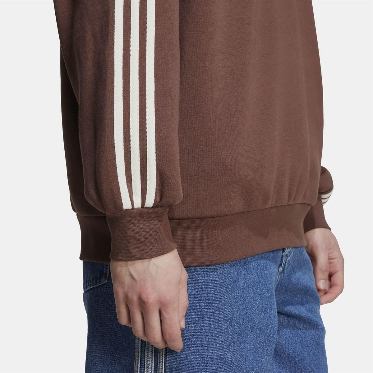 Brown sweatshirt with white triple stripes on sleeve and ribbed cuff