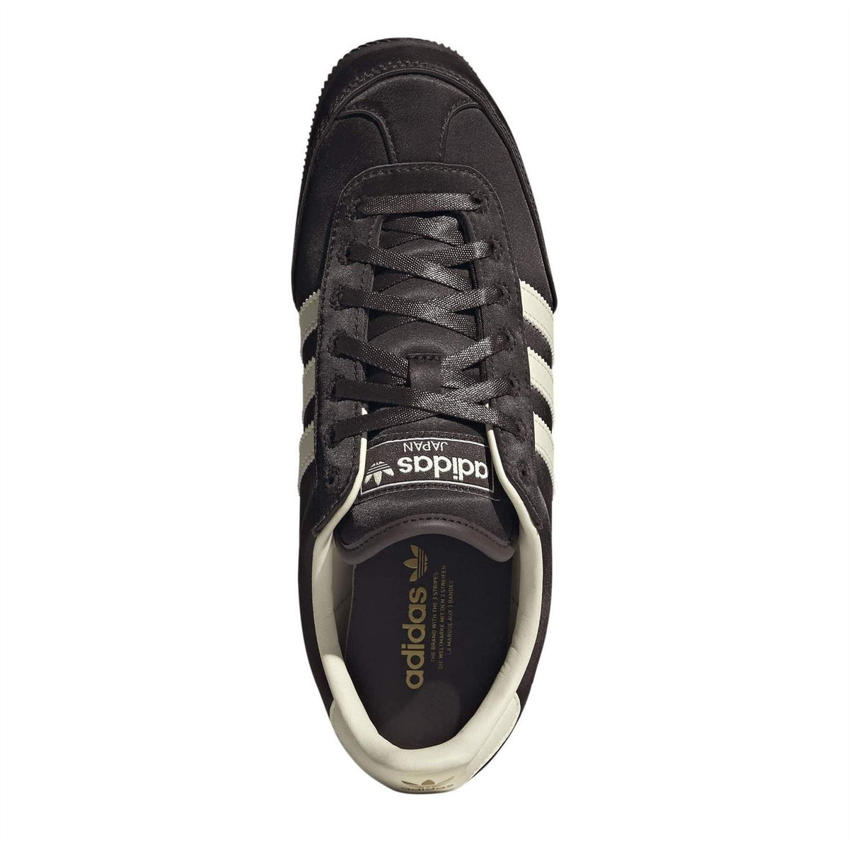 Adidas Originals lace-up sneakers with tongue label and black laces on dark upper
