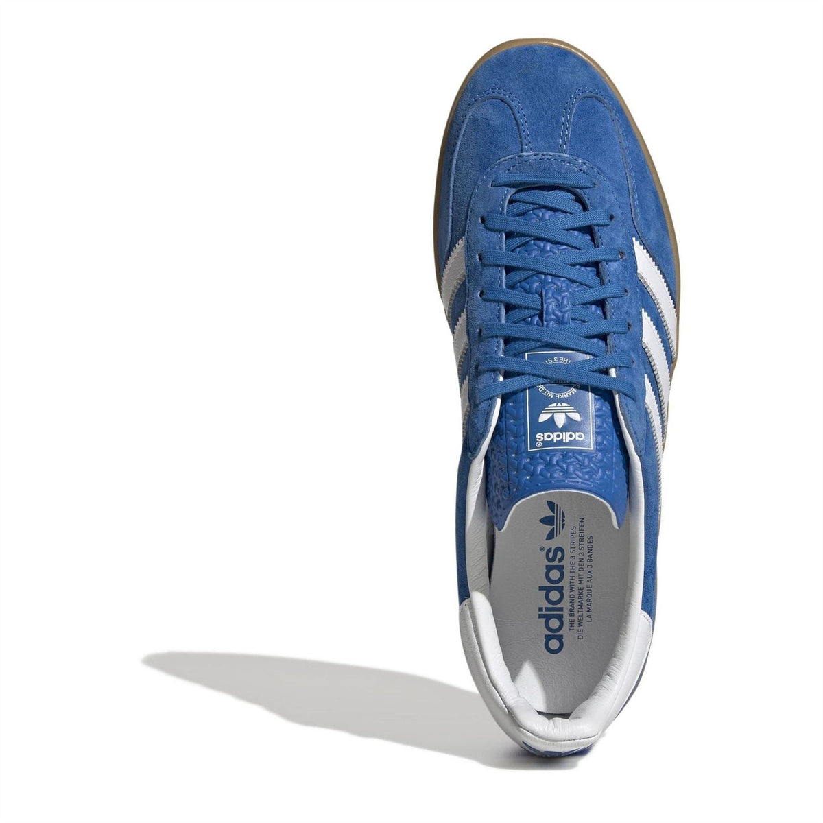 Blue suede sneaker viewed from toe with blue laces and white interior lining