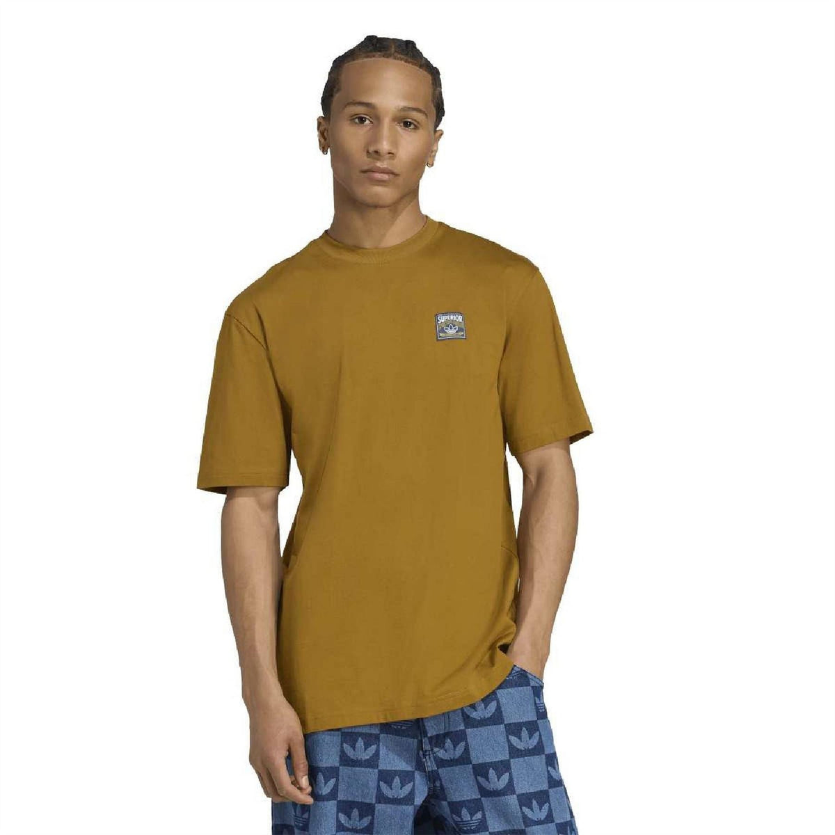 Mustard-gold crew neck short sleeve T-shirt worn with blue patterned pants