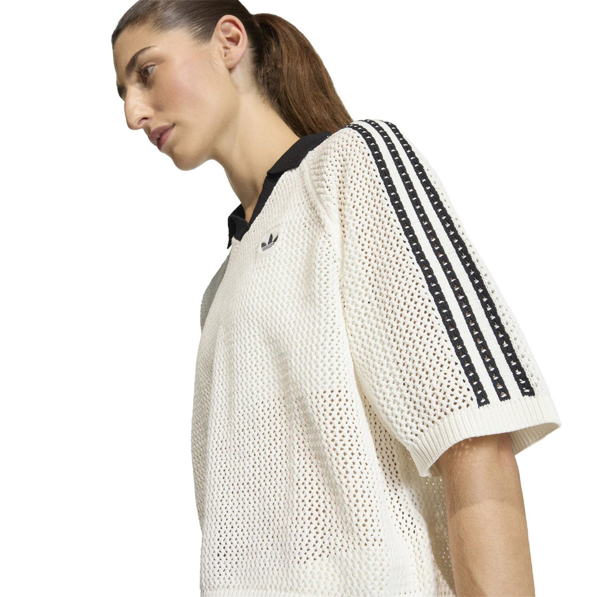 Off-white knit polo shirt side view with black triple stripes on sleeve