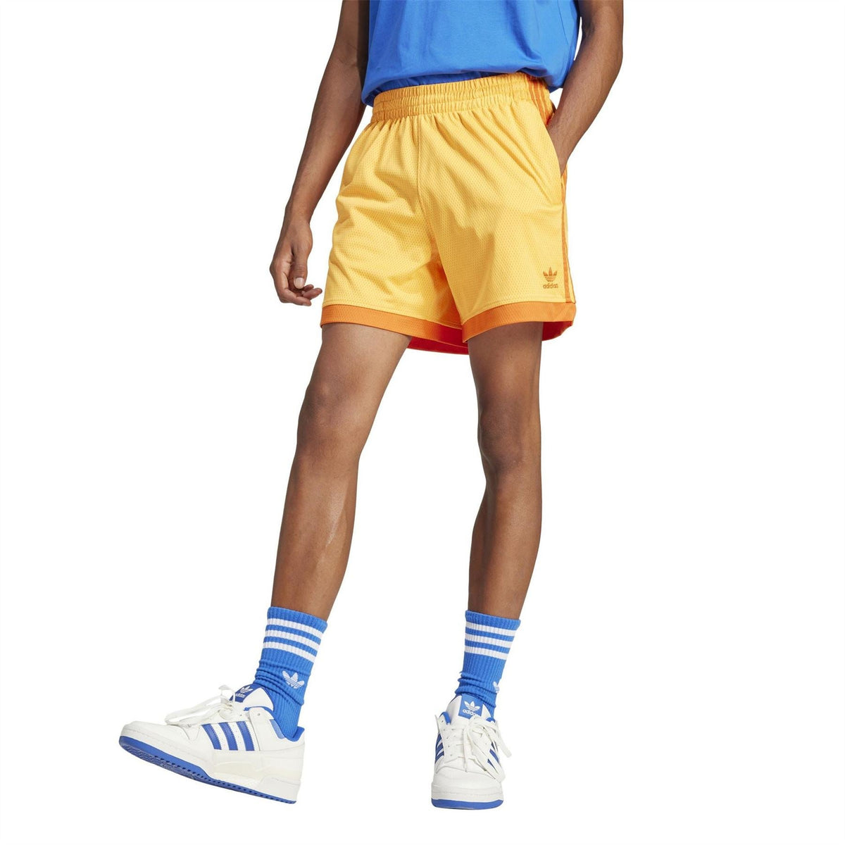 Yellow adidas Originals shorts with elastic waistband and trefoil logo, orange hem trim