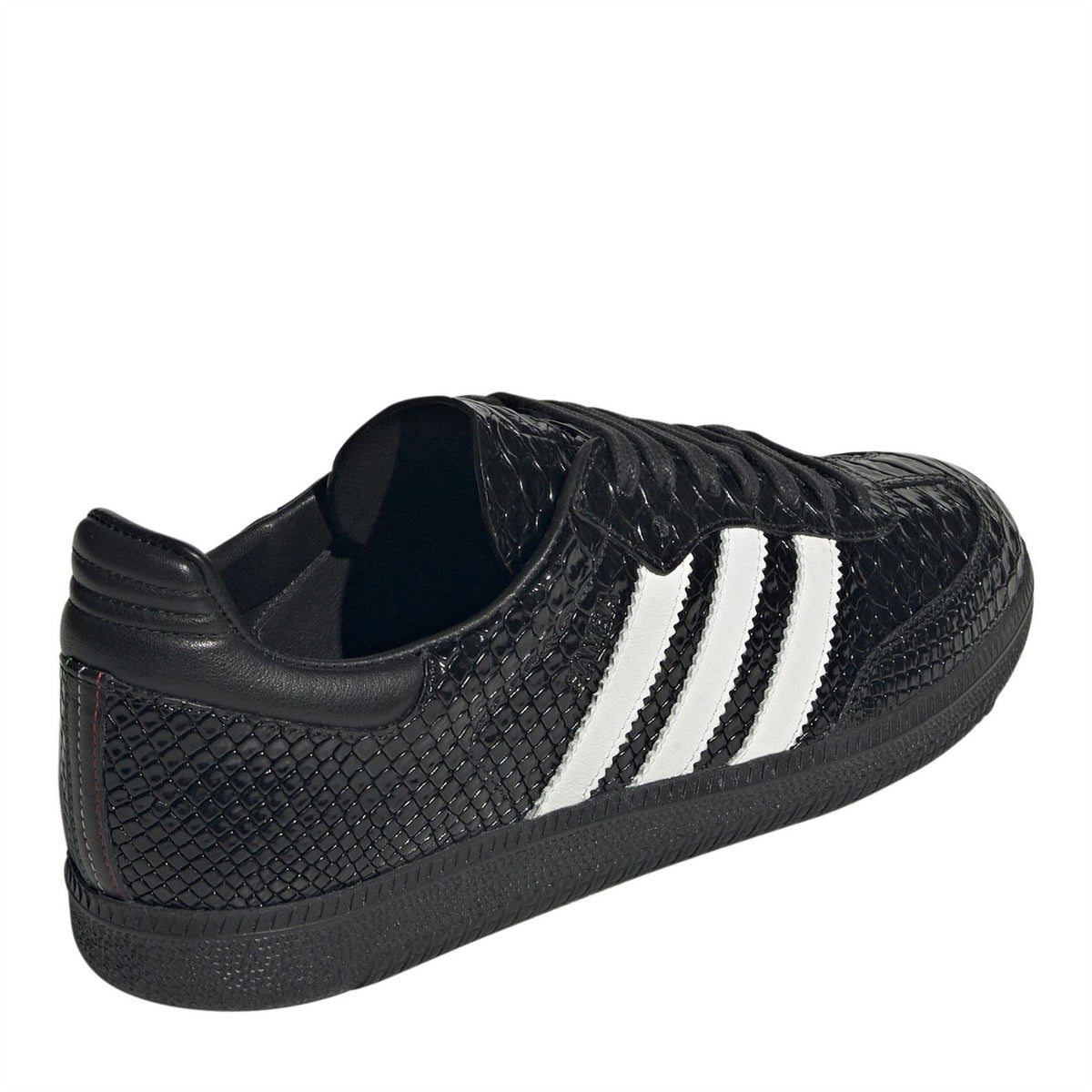 Black low-top sneakers with white triple stripes and black ankle padding