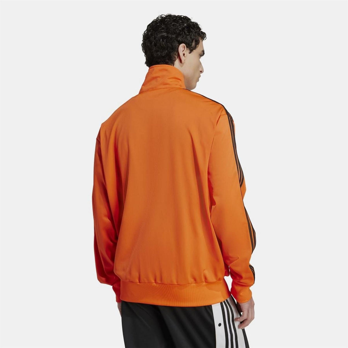 Orange adidas Originals Firebird track top, back view with black triple stripes