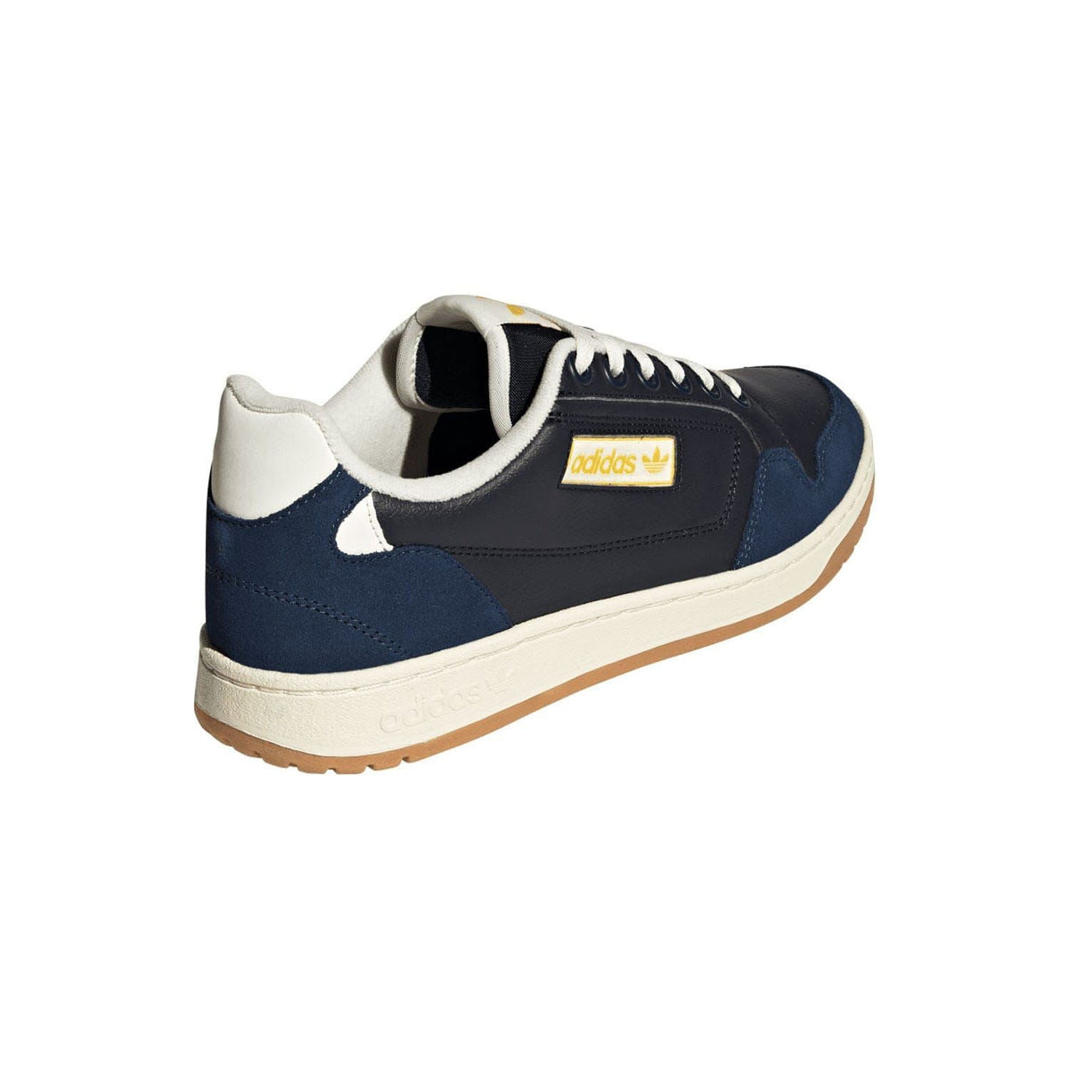 Rear 3/4 view of navy low-top sneakers with off-white sole and adidas logo tag