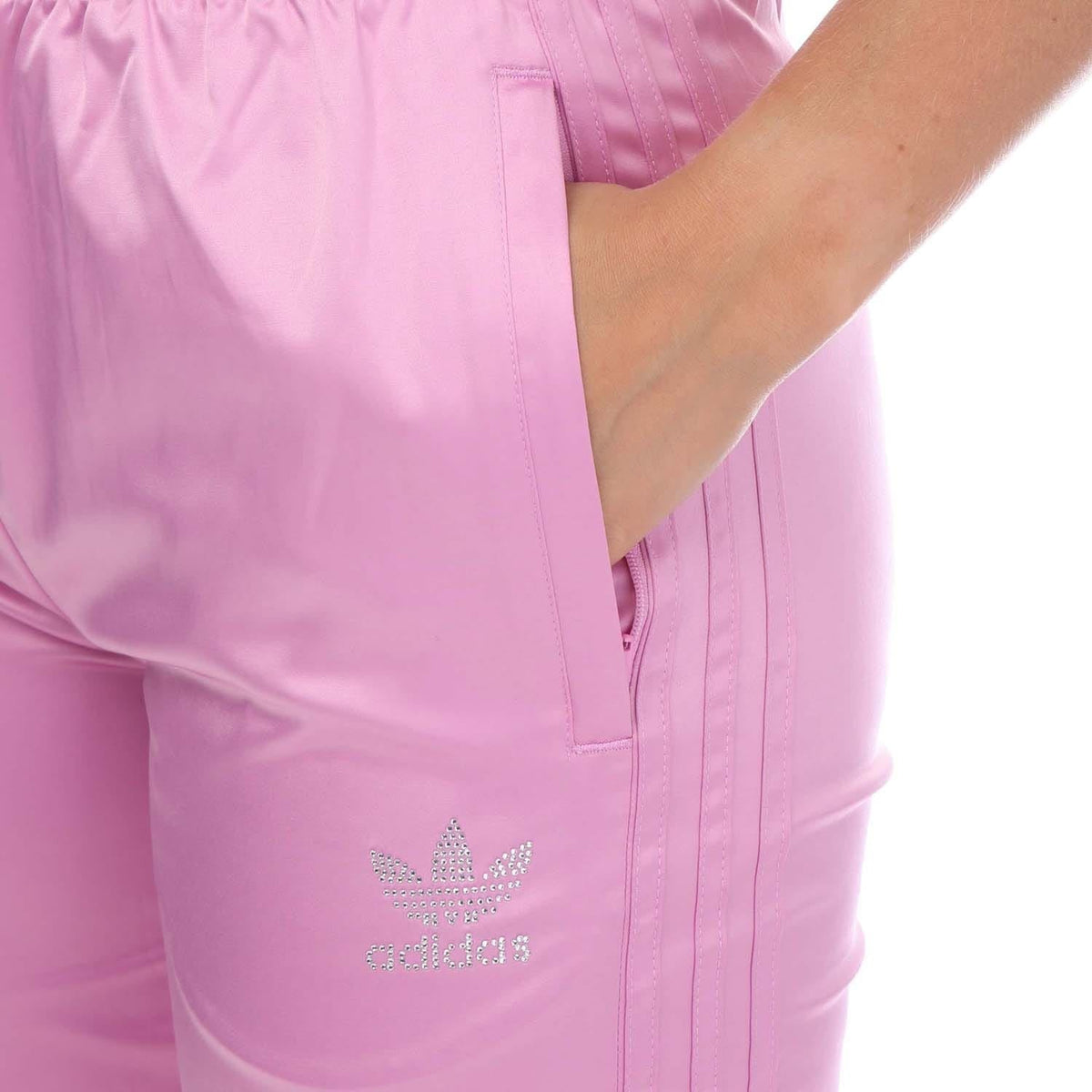 Pink jogger pants close-up with pocket seam and adidas Originals logo