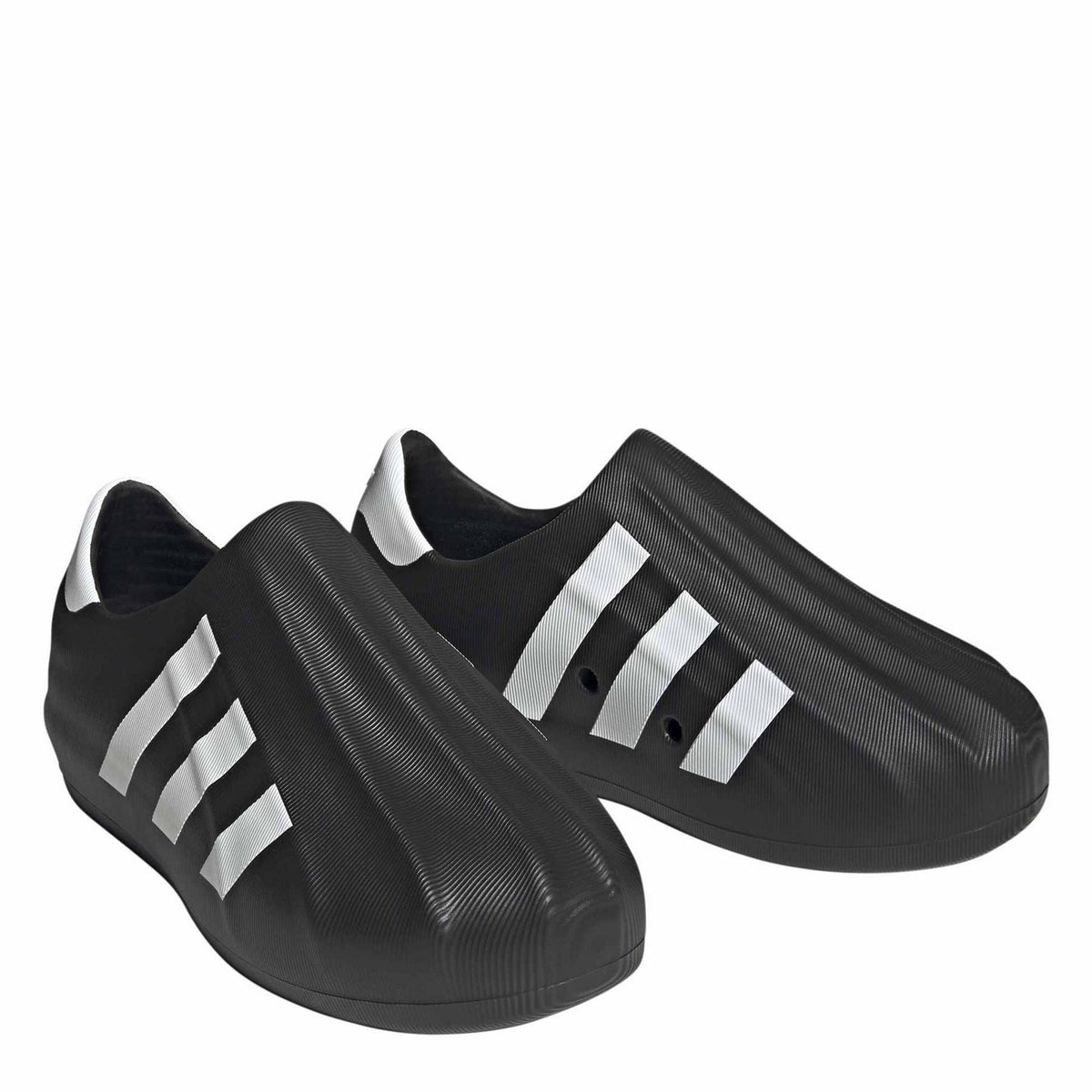 Pair of black slip-on sneakers with white adidas-style stripes on textured uppers