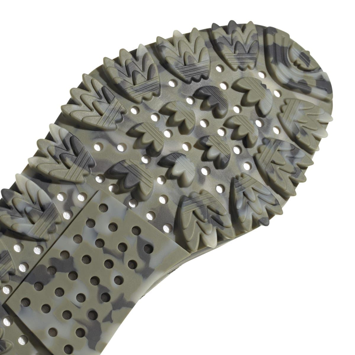 Close-up of dark olive outsole tread with raised rubber knobs and dotted traction