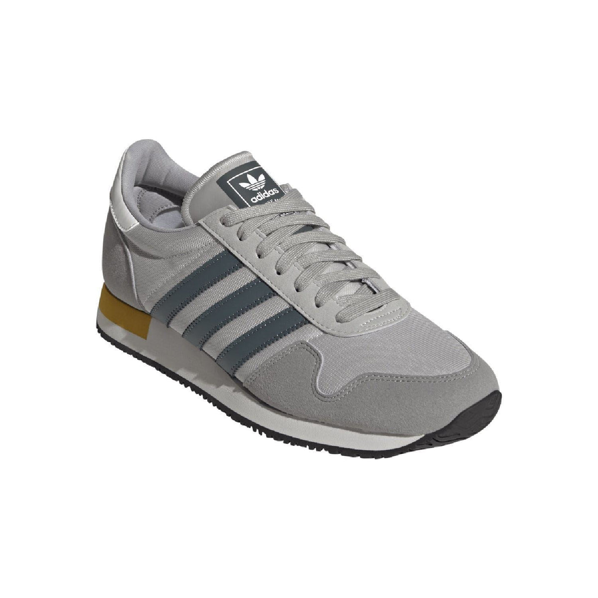 Grey adidas USA 84 trainers with blue stripes, lace-up front, and yellow sole edge