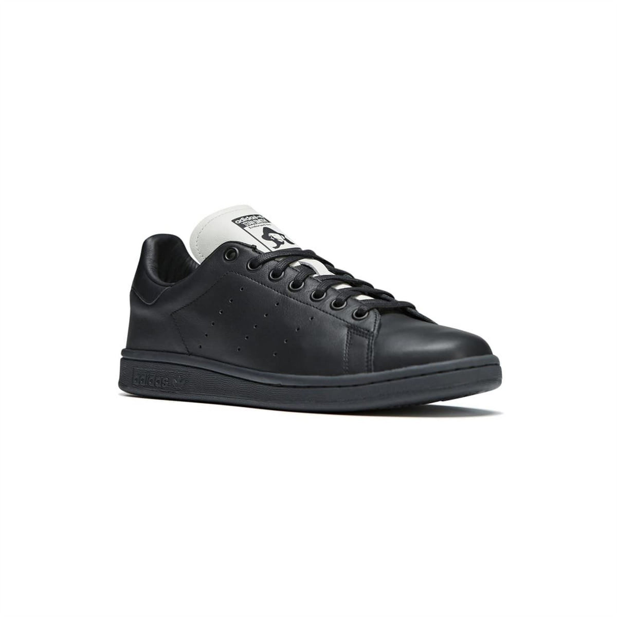 Black leather lace-up sneaker with white tongue patch, perforated detailing, and adidas branding