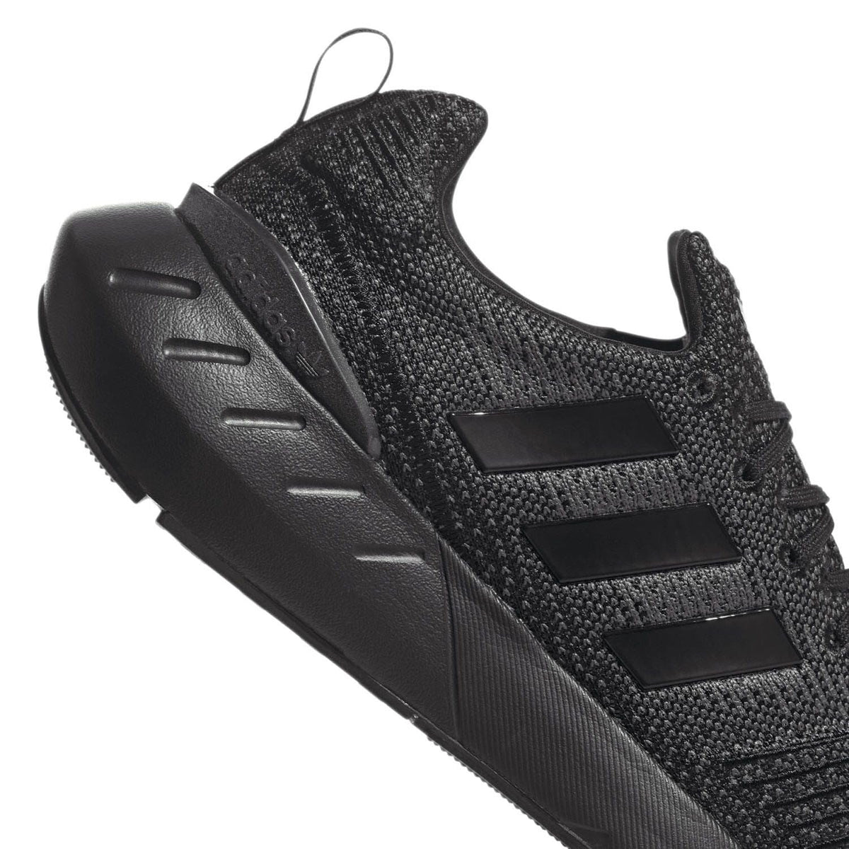 Black trainers with chunky rubber outsole and 3 side stripes on knit upper