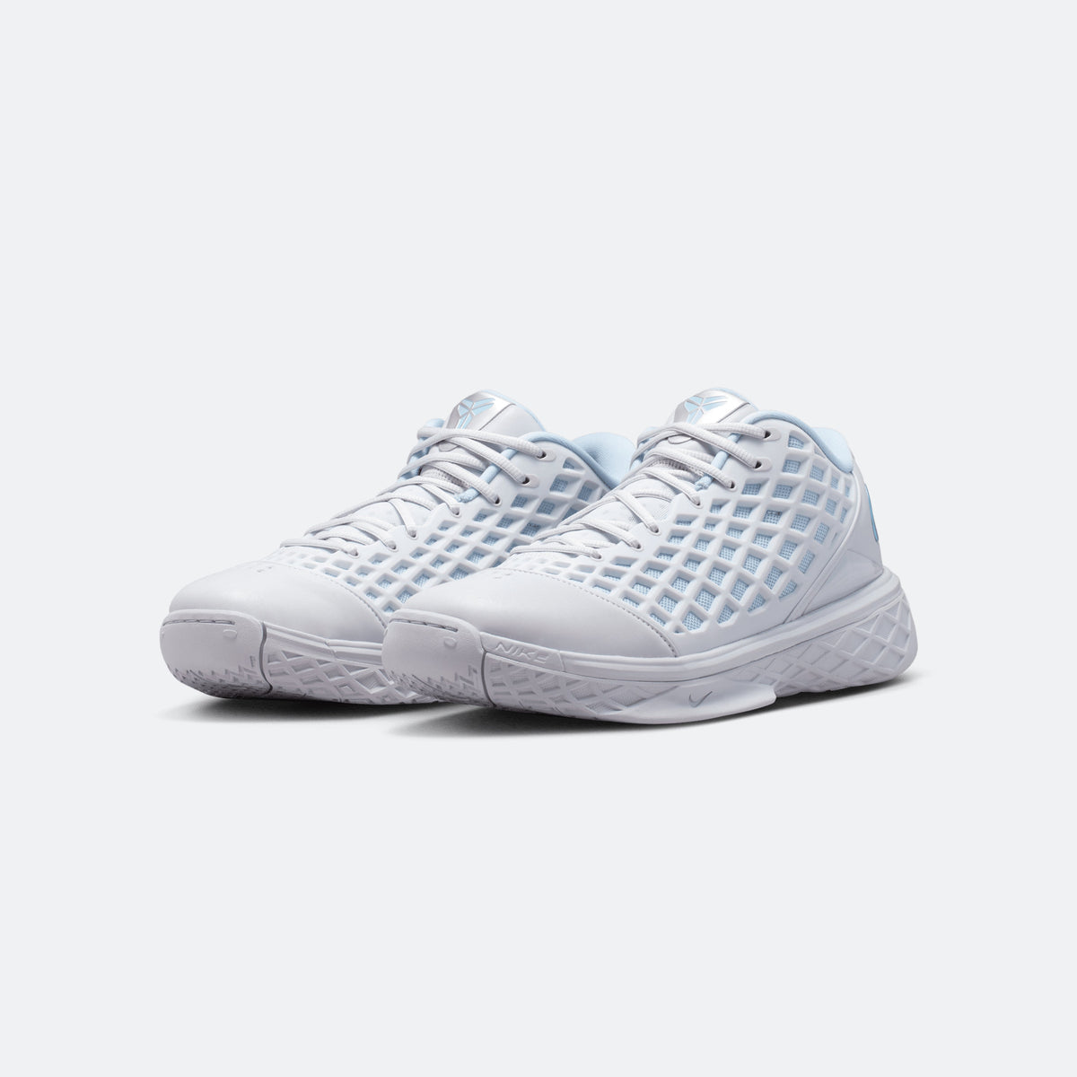 Pair of light blue and white lace-up basketball shoes with mesh side panels