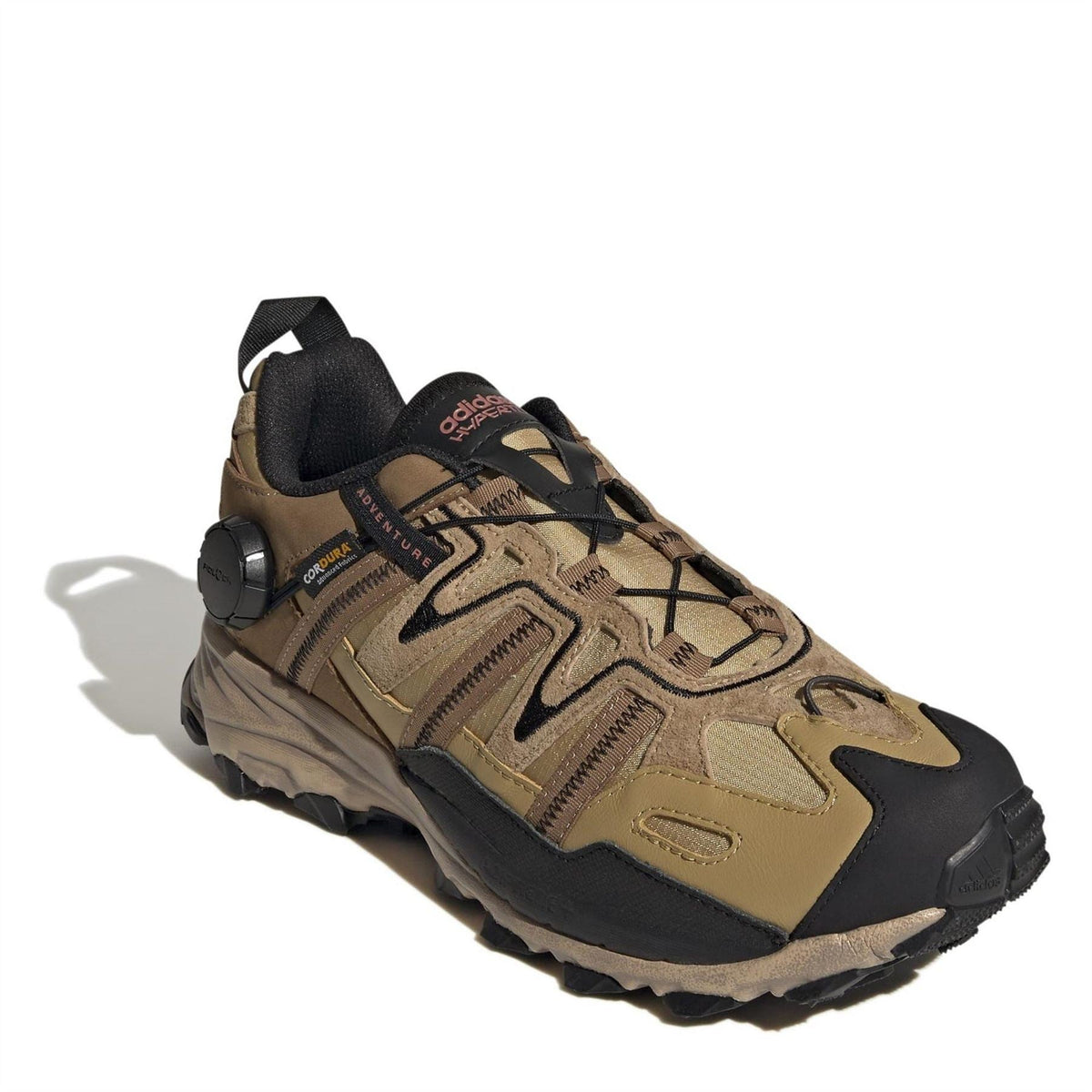 Beige and black lace-up hiking sneaker with textured panels and protective toe