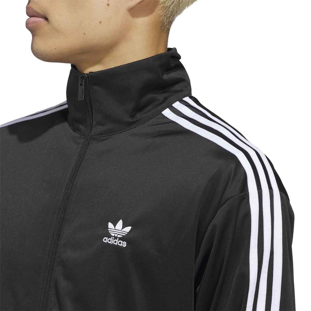 Men's black adidas track jacket close-up of stand collar, full zip, and logo