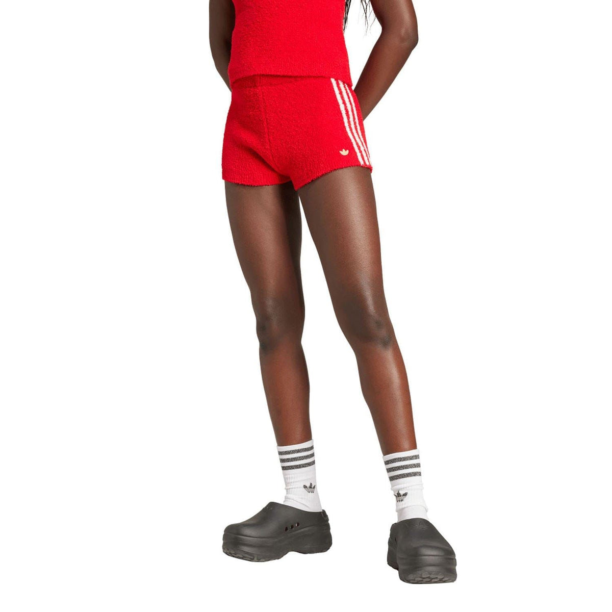 Red knit shorts with white adidas side stripes and ribbed waistband