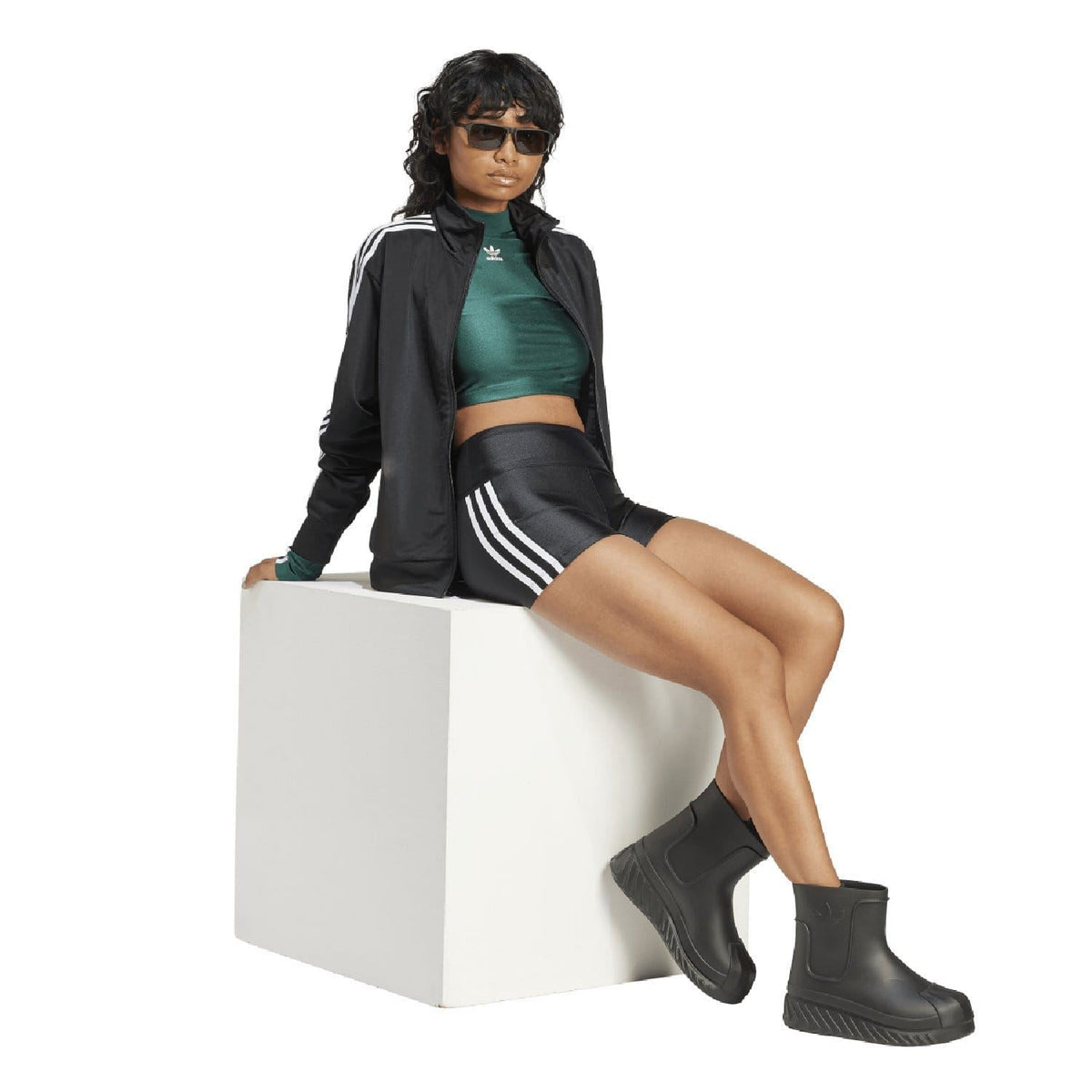 Black adidas track jacket with white triple stripes over full-zip front
