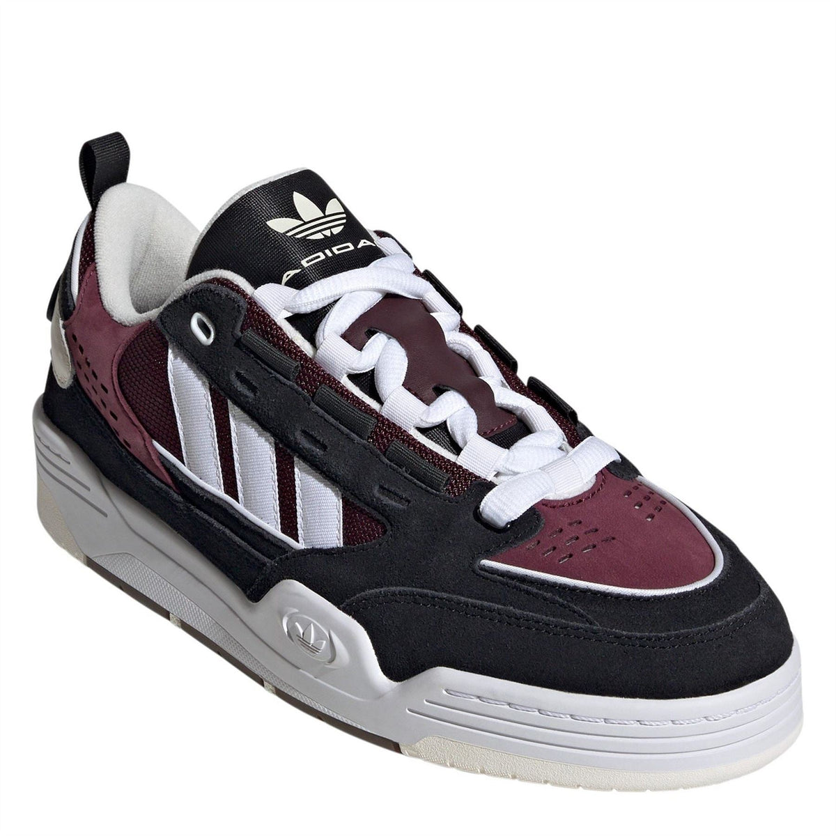 Kids' low-top trainers, angled view, black with burgundy suede and white laces