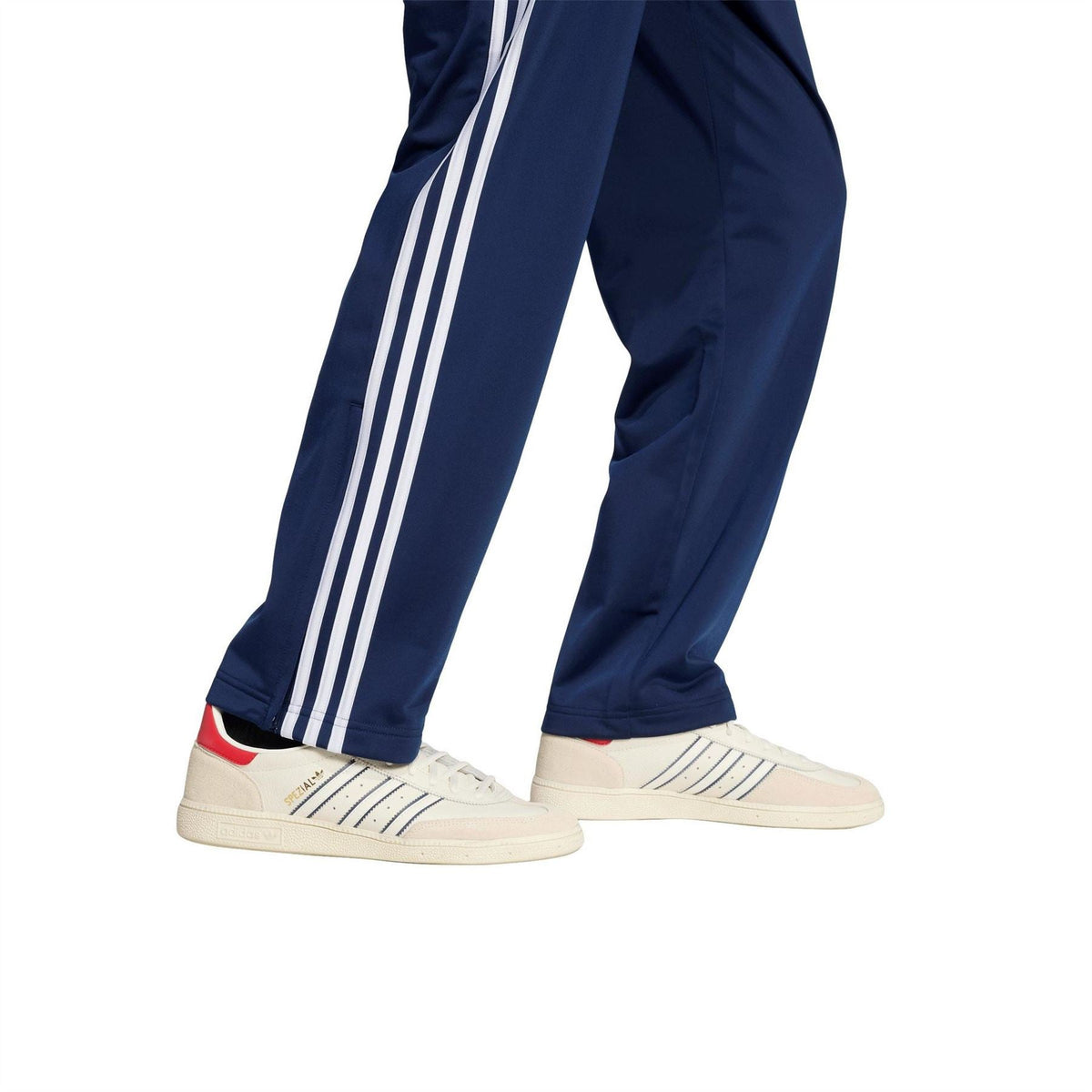 Men's navy woven track joggers with white side stripes and tapered open hem