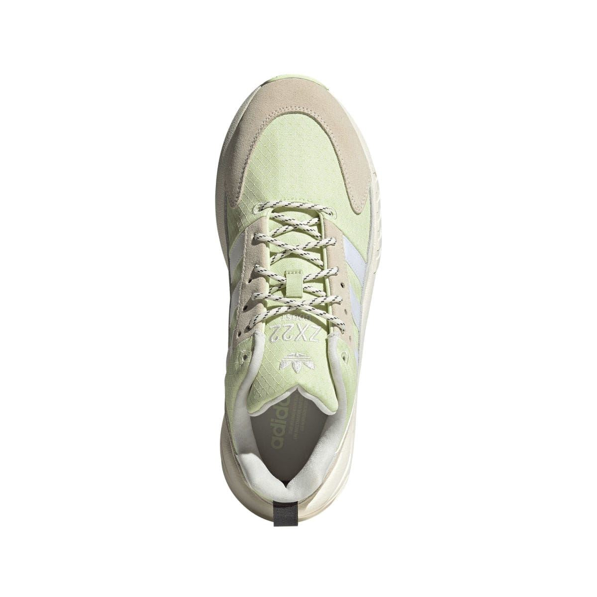 Light green and off white lace-up trainer with mesh lining and cushioned collar