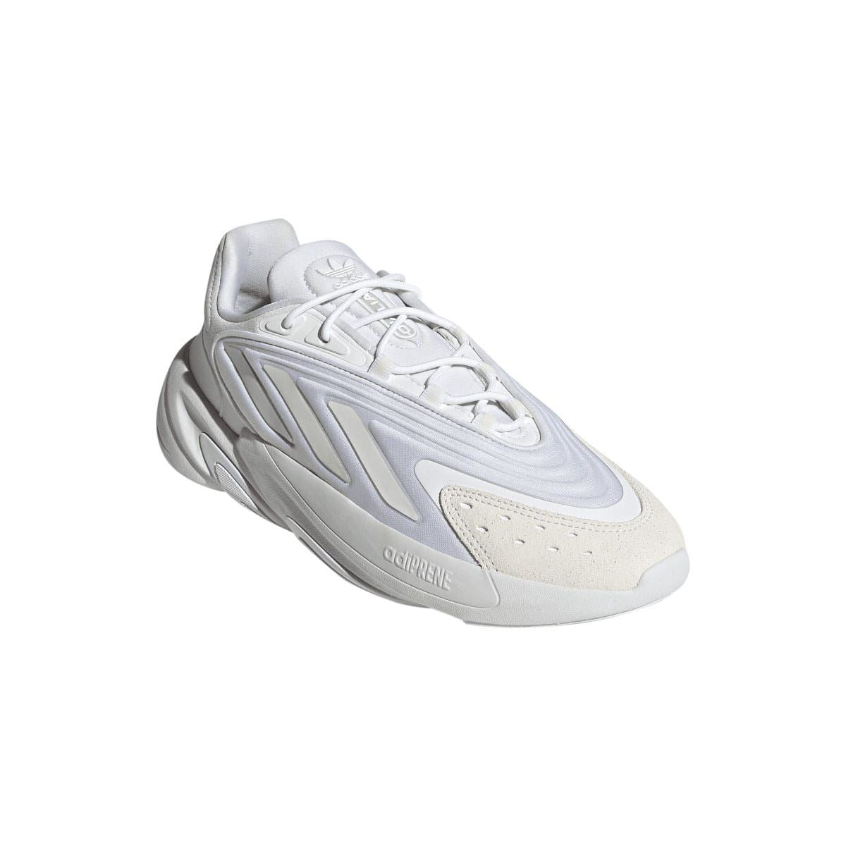 White adidas Ozelia trainers in angled view, side logo and ventilated panels
