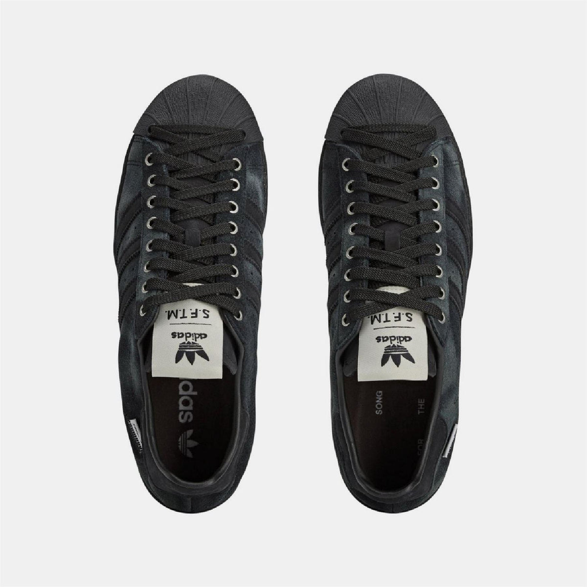 adidas Originals Superstar 82 trainers, classic white footwear with black stripes, side view showing iconic design and textured sole