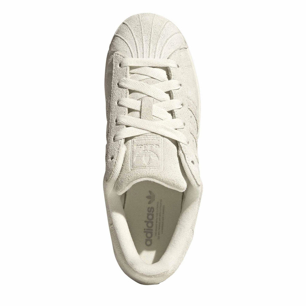 Light cream suede lace-up sneakers with printed insole details at the tongue
