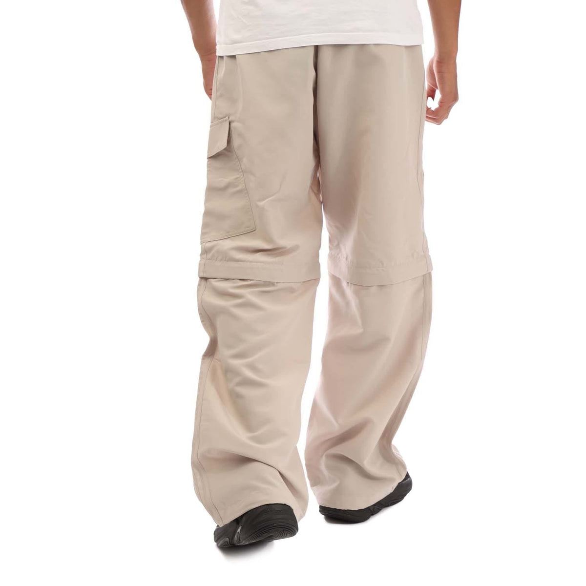 Beige wide-leg zip-off joggers with patch pockets and elastic cuff