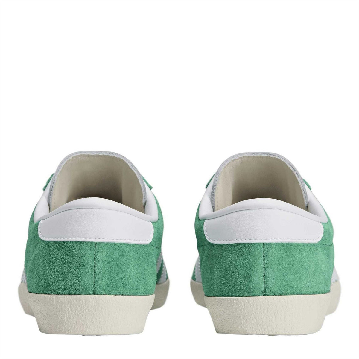 Pair of court-style trainers from the heel, court green suede with white trim