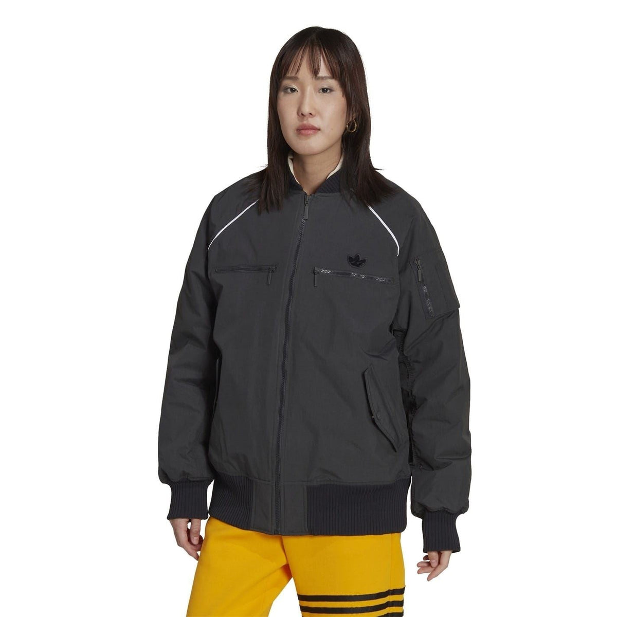 Dark zip-up bomber jacket with stand collar, zipped front, flap pockets, ribbed cuffs.