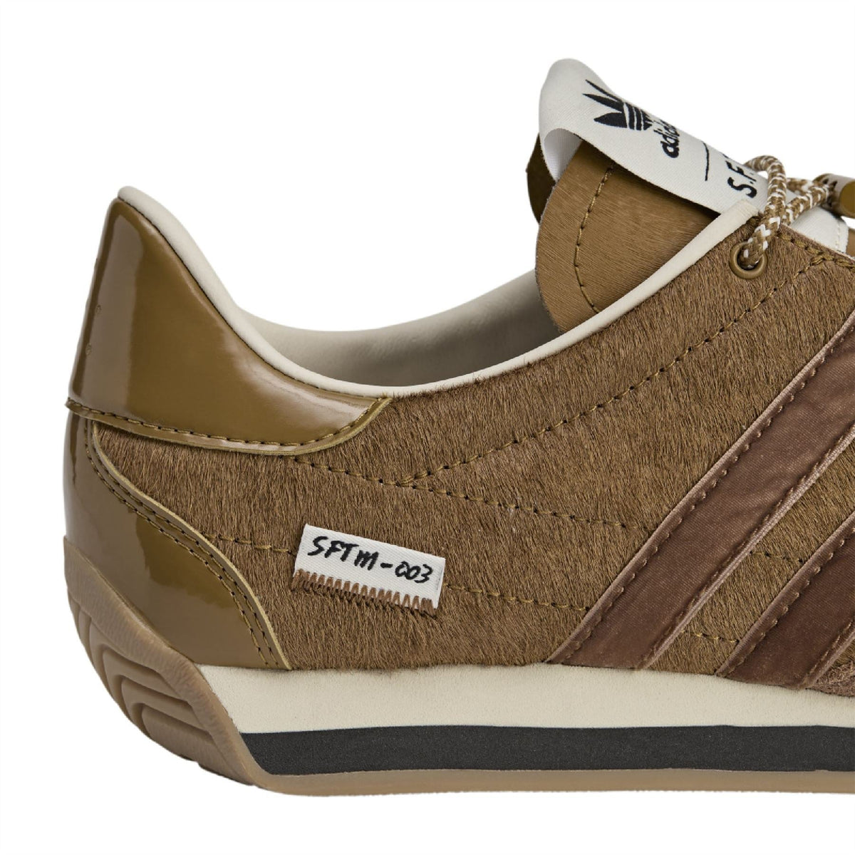 Bronze adidas Originals sneaker close-up, white collar lining and lace area